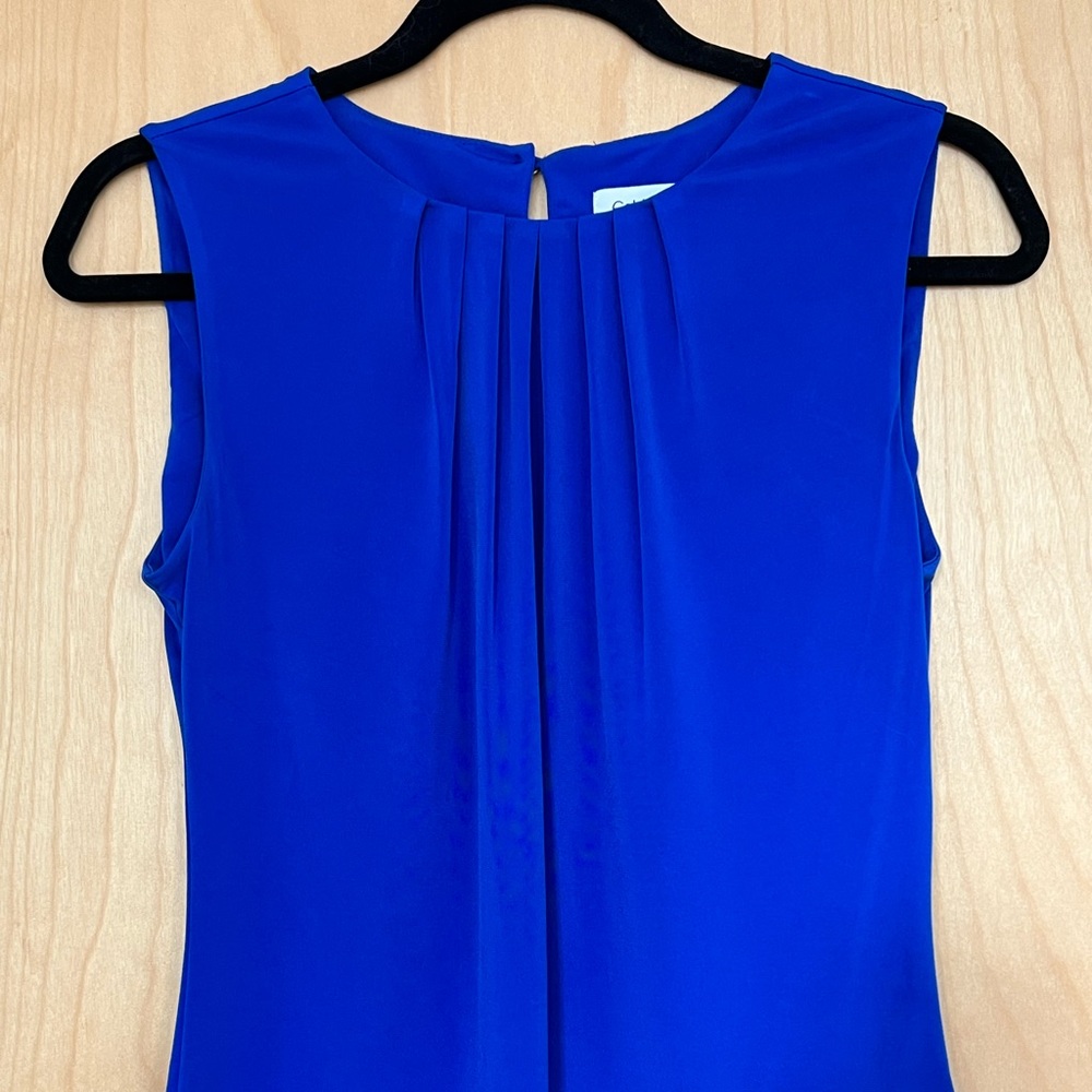 Stunning blue Calvin Klein shell top with pleated detail in front.